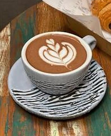 Hot latte with rosetta latte art