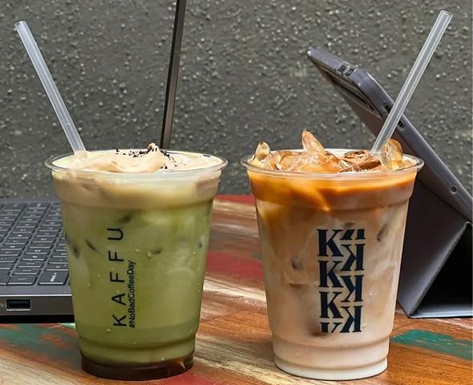 Two iced drinks next to a laptop